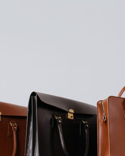 Close-up of three elegant leather briefcases side by side