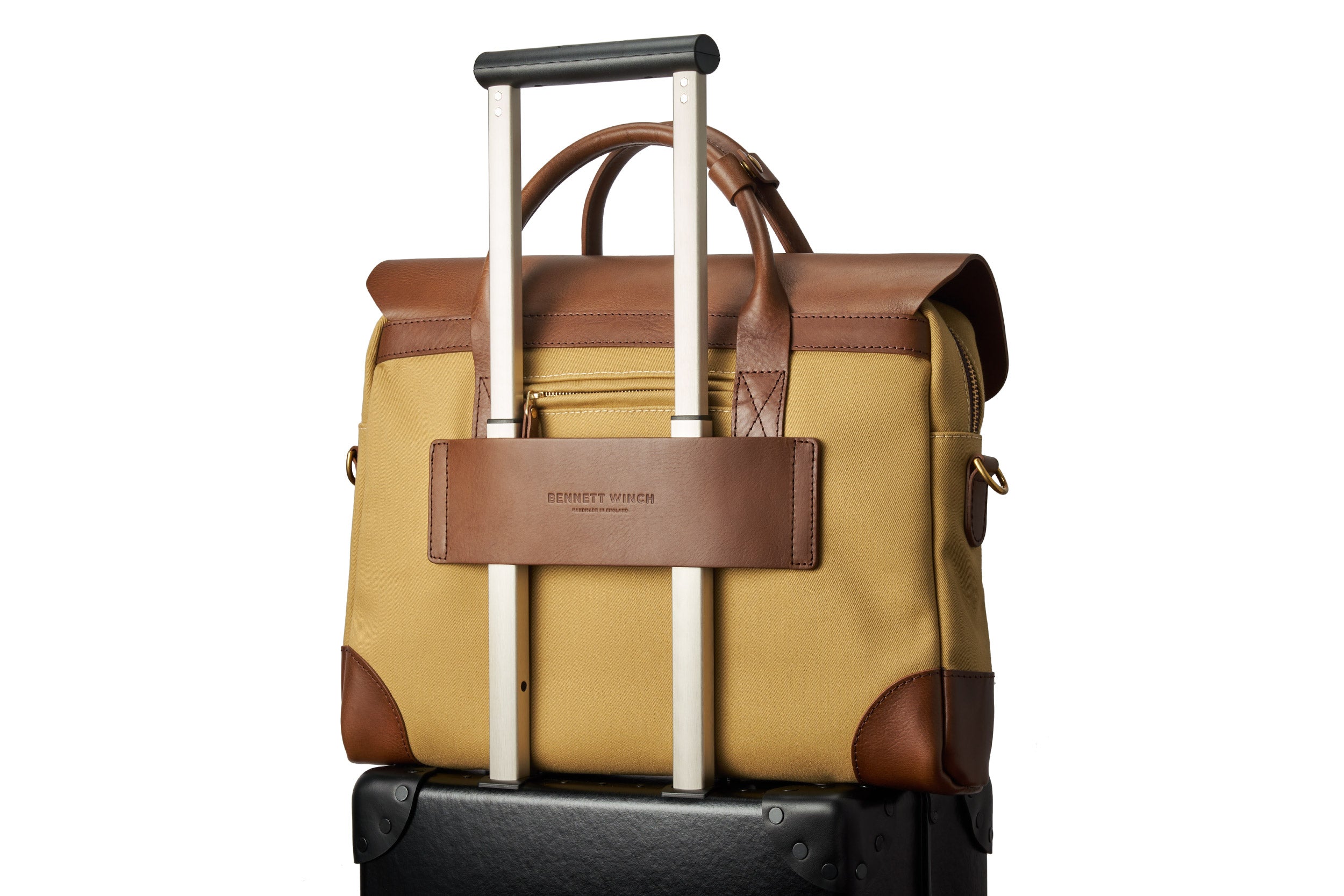 Bennett Winch The Brief briefcase's rear leather panel slipped over a wheeled suitcase trolley handle